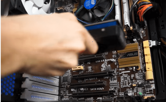 Can You Upgrade a Prebuilt Gaming PC? Yes, the photo shows a person upgrading the GPU of a gaming PC
